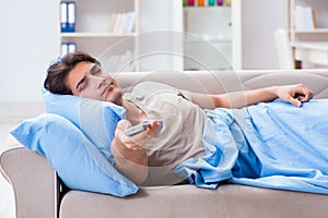 The man watching tv from bed holding remote control unit