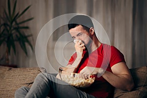 Man Watching TV Eating Pop Corn