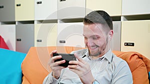 Man watching videos on the smartphone indoors