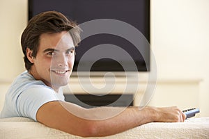 Man Watching Widescreen TV At Home