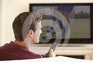 Man Watching Widescreen TV At Home