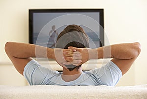 Man Watching Widescreen TV At Home photo