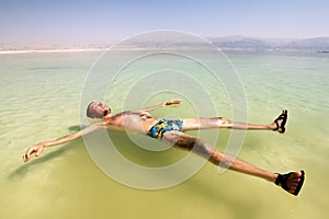 A man on the water of the dead sea in Israel