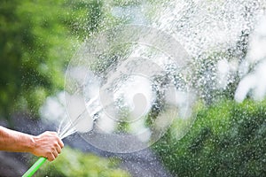 Man watering the garden from hose