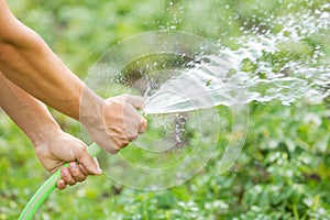 Man watering the garden from hose