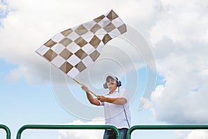 Man waves a checkered flag