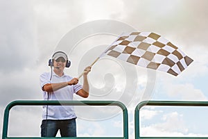 Man waves a checkered flag