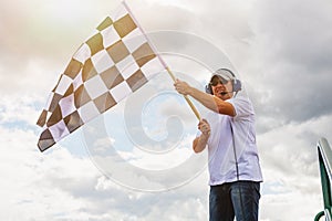 Man waves a checkered flag