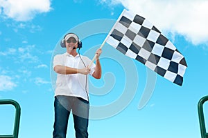 Man waving a checkered flag on a raceway