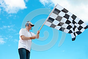 Man waving a checkered flag on a raceway