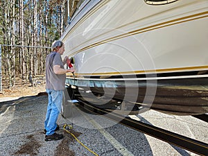 Man Waxing a Power Boat Hull