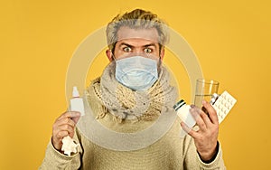 Man wear respirator mask. cough cold and runny nose remedy. man ready to take a pill. ill man at home. sneezing and