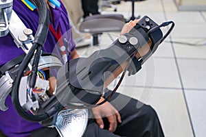 Man wear robot arm for physical therapy. By defining how a robot driven moving technique can be improved to achieve better results photo