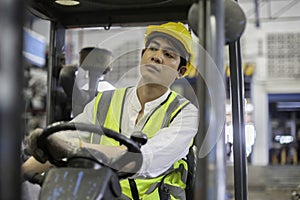 Man wear safety helmet driver forklift warehouse in factory. Male worker industrial operate. control loading container box.