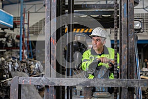 Man wear safety helmet driver forklift warehouse in factory. Male worker industrial operate. control loading container box.