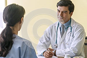 Man wear uniform with pen and stethoscope sitting in office while talking about problem health patient woman fell friendly