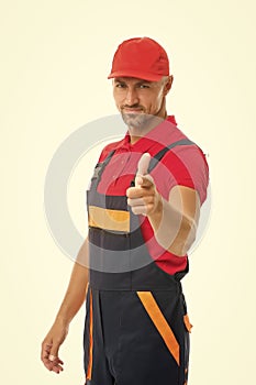 man wear working overall. handsome worker in uniform. building engineer pointing finger. mature skilled laborer in cap