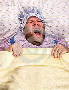 Man weared as baby in bed