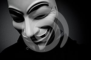 Man wearing anonymous mask . This mask is a well-known symbol for the online hacktivist