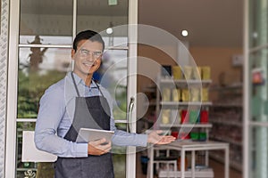 Man wearing apron smiling welcoming guests having prosperous catering business concept