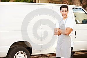Man Wearing Apron Standing In Front Of Van