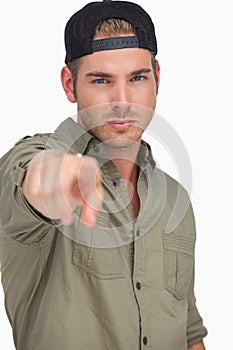 Man wearing baseball hat backwards and pointing