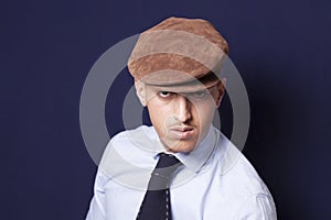 Man wearing beanie and necktie and looking