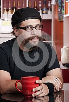 Man wearing beret in coffee house