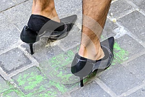 Man wearing a black high heels shoes