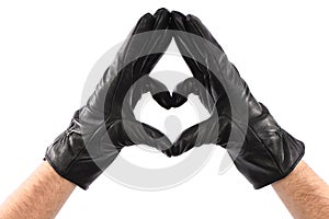 Man wearing black leather glove on white background, closeup, heart sign, Love