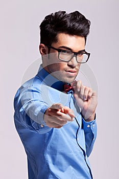Man wearing bow tie pointing to the camera