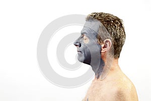 Man Wearing a Charcoal Bentonite Mask photo