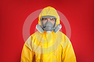 Man wearing chemical protective suit on background. Prevention of virus spread