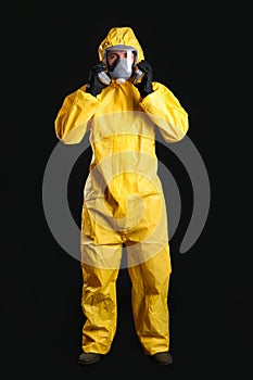 Man wearing chemical protective suit on background. Virus research