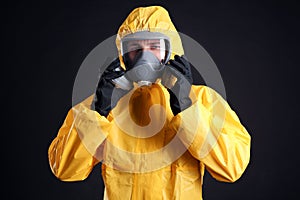 Man wearing chemical protective suit on background. Virus research