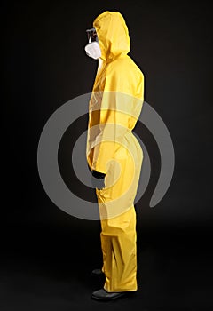 Man wearing chemical protective suit on background. Virus research