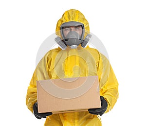 Man wearing chemical protective suit with cardboard box on background. Prevention of virus spread