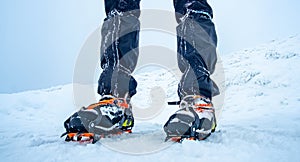 Man wearing crampons standing on snow