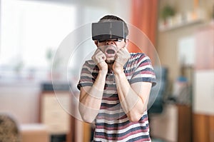 Man is wearing 3D virtual reality headset and is scared of something