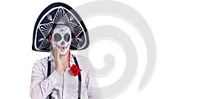 Man wearing day of the dead costume over background touching mouth with hand with painful expression because of toothache or