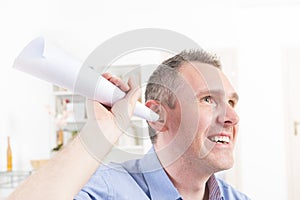 Man wearing deaf aid trying to hear something