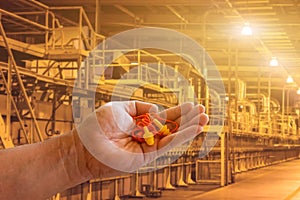 Man wearing ear plugs hearing protection for factory worker,safety concept