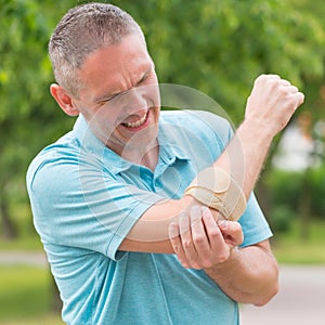 Man wearing elbow brace photo