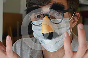 Man wearing face mask and Groucho glasses