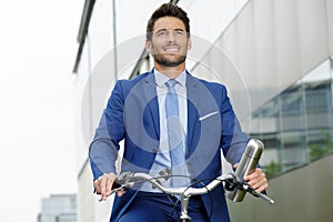 man wearing formal clothing riding bicycle