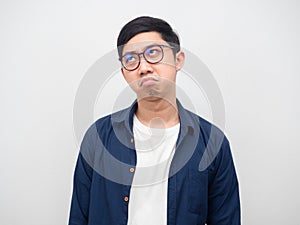 Man wearing glasses feeling bored looking up on space white background