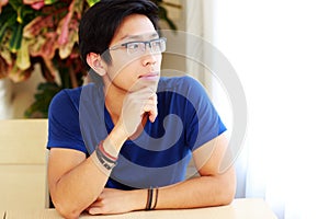 Man wearing glasses sitting at the table