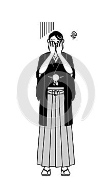 Man wearing Hakama with crest covering his face in depression