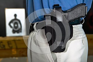 Man wearing a handgun in a webbing holster photo