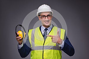 The man wearing hard hat and construction vest